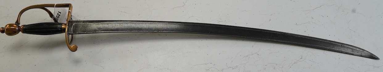 An English officer’s hanger, c.1800. brass grip with scrolling side bar, fluted ebony grip, blade 74.5cm. Condition - fair, guard significantly altered